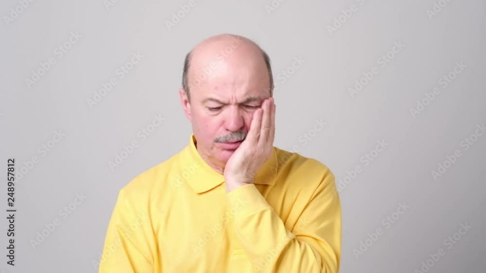 Senior man suffering with terrible toothache