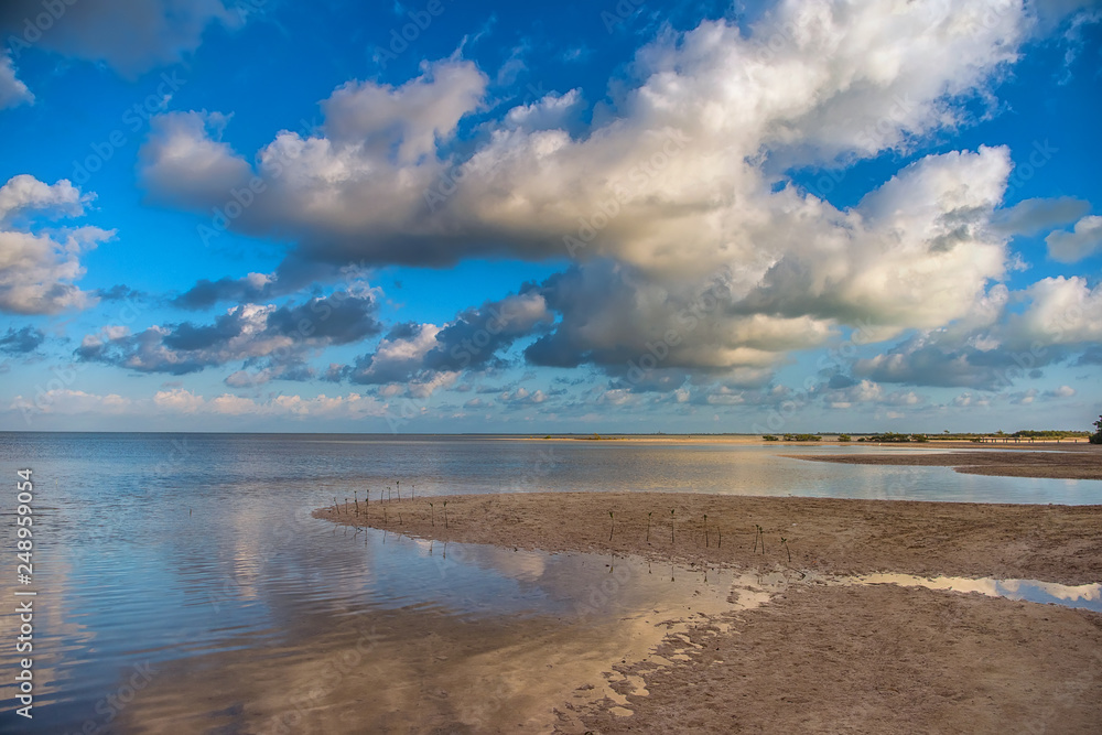 The sky with clouds reflected in the waters of the estuary.