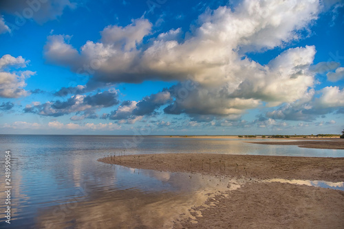 The sky with clouds reflected in the waters of the estuary.