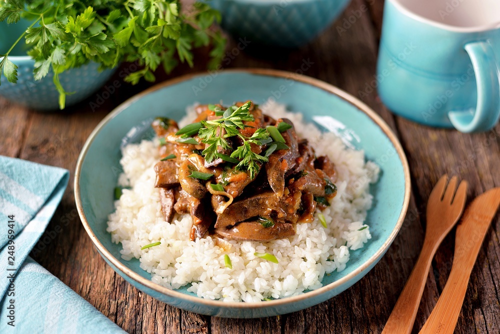 Stewed liver in a sauce with onion, carrot and parsley and boiled rice. Stewed liver in a sauce with onion, carrot and parsley and boiled rice.