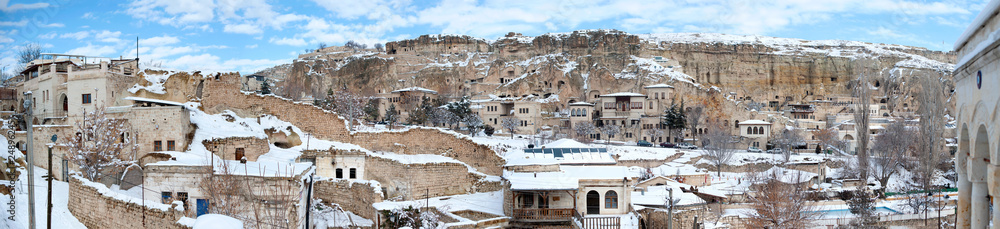 Old stone and cave houses panorama in the ancient town of snowy winter time in Urgup, Nevsehir. The city has been added to unesco world heritages list.