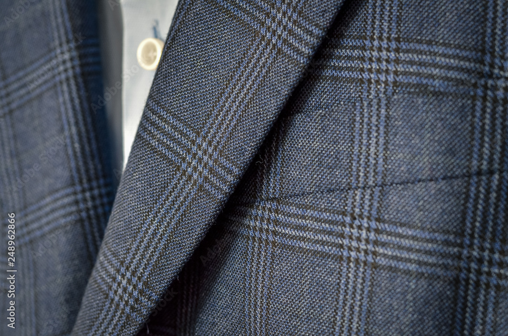 Close up of dark blue checked suit with lapels fragment Close up of dark blue checked suit with lapels fragment