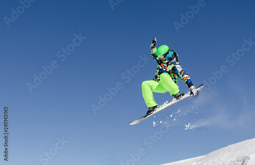 First plane of a snowboarder jumping in a sunny day in Aspen ski resort, United States