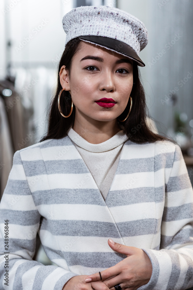 Young asian beaming woman with red lipstick looking contented Young asian beaming woman with red lipstick looking contented