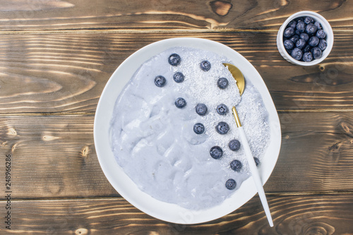 Top view of blue yogurt smoothie bowl made with blueberry