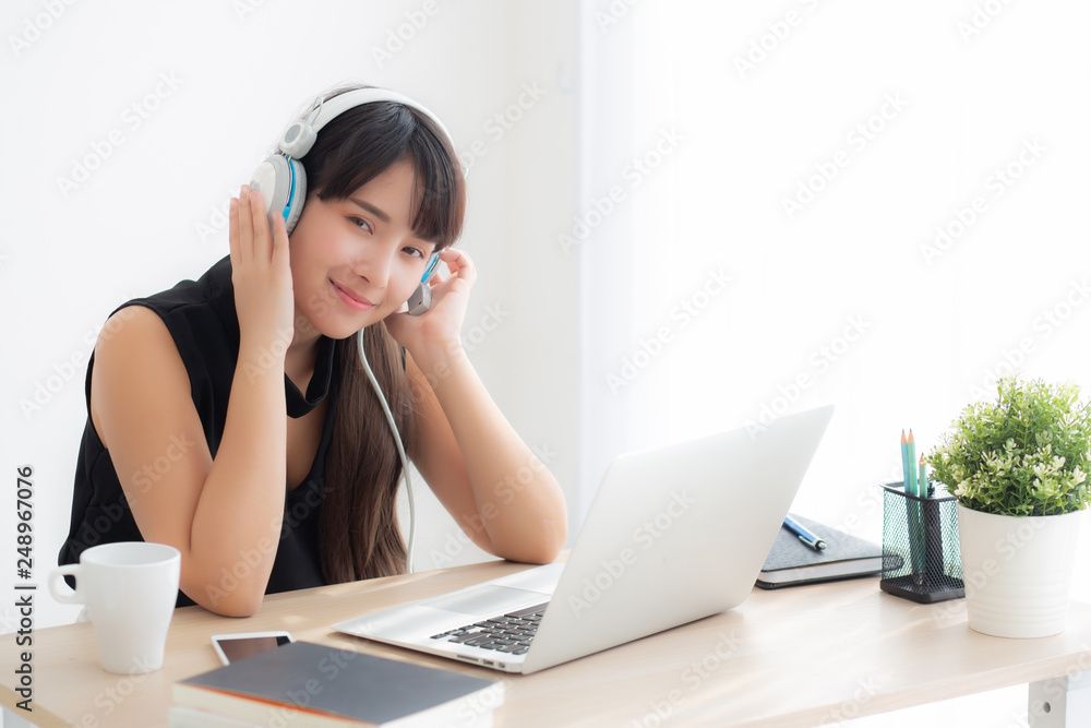 Beautiful young asian woman wear headphone smiling say hello using chat video call on laptop computer, girl relax enjoy listening music online, education learning, communication and lifestyle concept. Beautiful young asian woman wear headphone smiling say hello using chat video call on laptop computer, girl relax enjoy listening music online, education learning, communication and lifestyle concept.