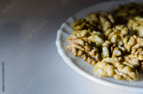 Pieces of walnuts on the white plate