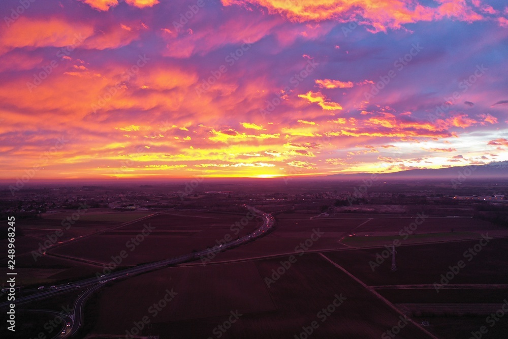 view from above. unbelievably beautiful sunset. clouds are highlighted in pink, purple and yellow-orange colors