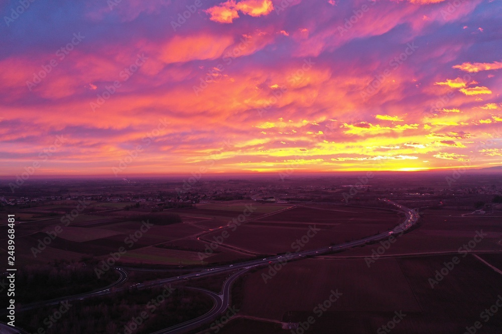 fiery sanset from drone. view from above. unbelievably beautiful sunset. clouds are highlighted in pink, purple and yellow-orange colors