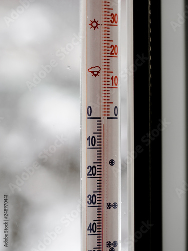thermometer with low temperature in the snowy cold weather, outside, cold degrees.