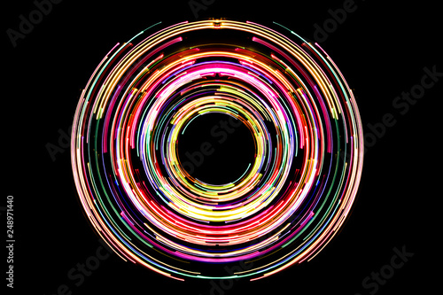 Abstract neon circle lines with empty copy space inside isolated on black background. Colorful led lights long exposure rotation photo. photo