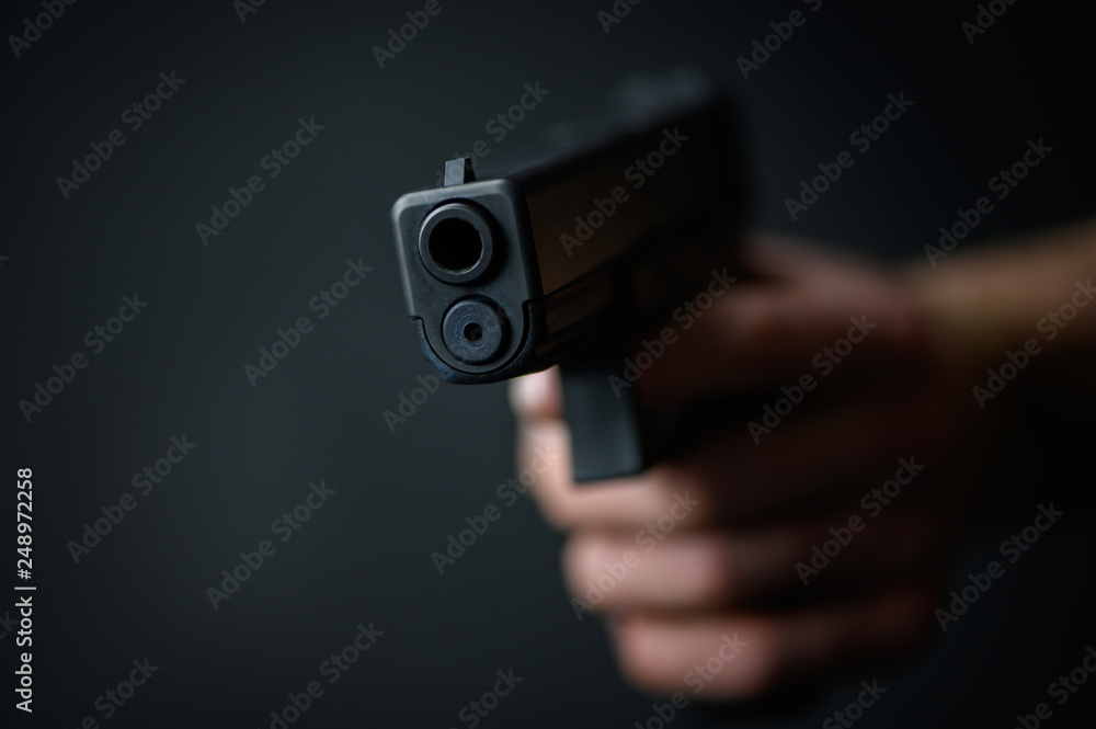 Man with a pistol in the hand closeup Man with a pistol in the hand closeup