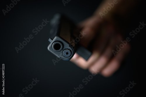 Man with a pistol in the hand closeup