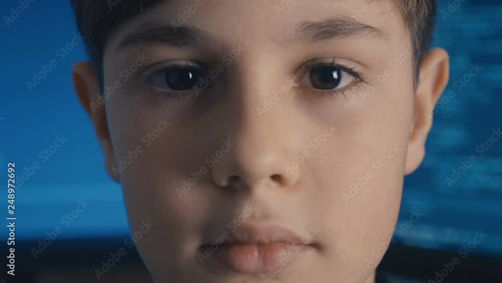 Close-up Prodigy Boy Hacker Programmer at data center filled with monitor screens Close-up Prodigy Boy Hacker Programmer at data center filled with monitor screens