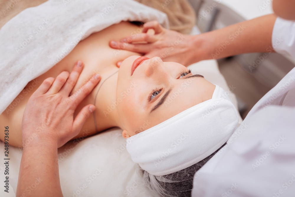 Top view of a beautiful young woman having massage Top view of a beautiful young woman having massage