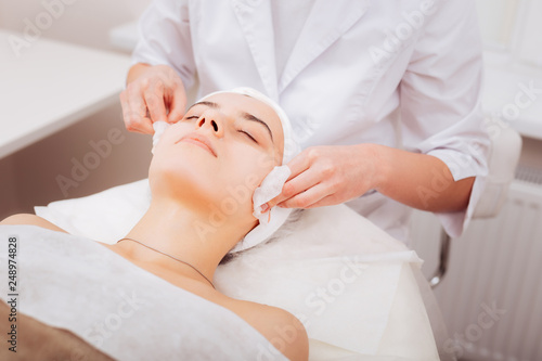 Nice attractive woman having her skin cleansed