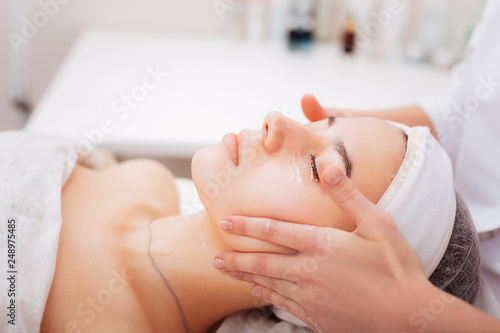 Pleasant young woman enjoying the cosmetology treatment