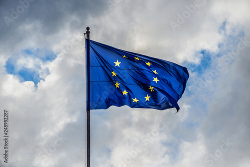 Problem in Europe. Dark and stormy clouds gather over European Union Flag