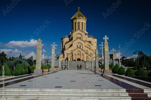 Front view of Holy Trinity Cathedral in Tbilisi with blue sky above