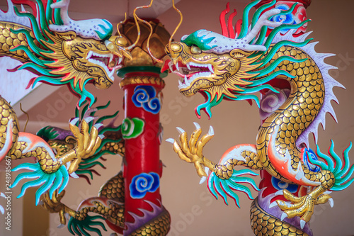 Wallpaper Mural Colorful statue of Chinese dragon wrapped around red pillar. Beautiful statue of dragon carved around temple pole in Chinese public temple. Torontodigital.ca