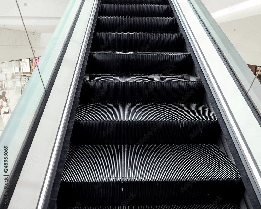 Modern escalator electronic system moving in the shopping center Modern escalator electronic system moving in the shopping center