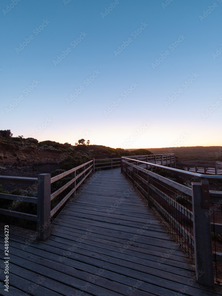 Empty wooded walkway at Great Ocean Road, VIC, Australia at dawn time.