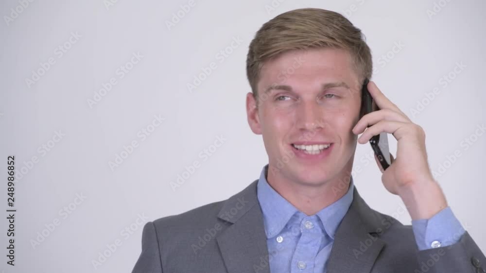 Face of happy young handsome businessman talking on the phone Face of happy young handsome businessman talking on the phone