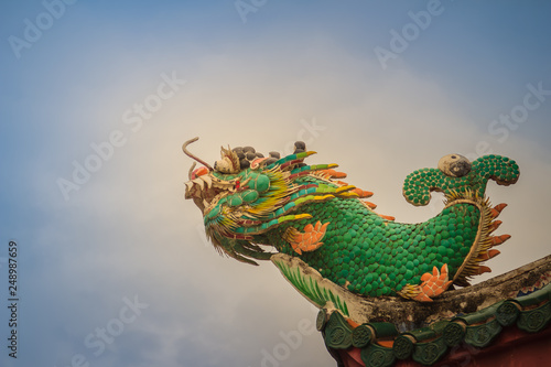 Beautiful dragon fish statue on the roof of Chinese temple.