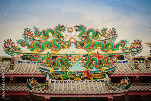 Colorful chinese dragon statues on roof in Chinese temple. Chinese dragons on the roof top of shrine.
