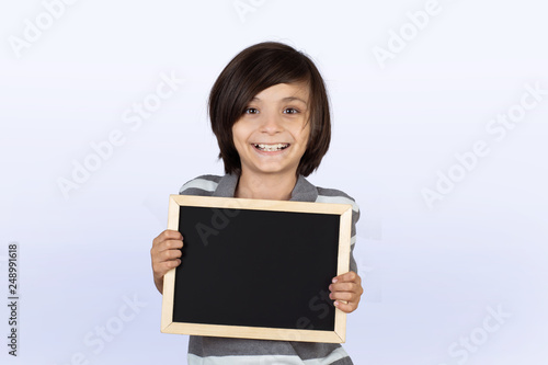 Little boy holding chalkboard.