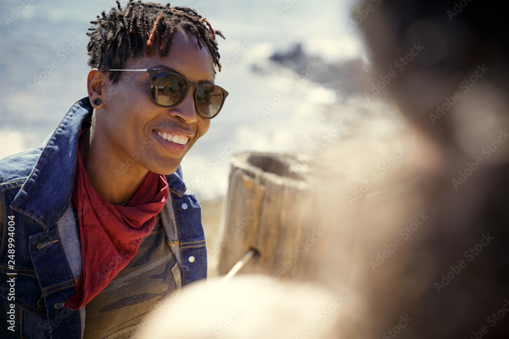 Smiling Woman in Conversation at the beach Smiling Woman in Conversation at the beach