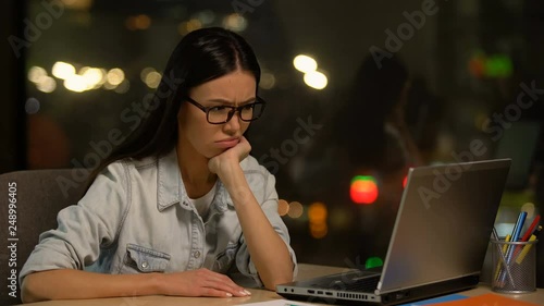 Dreamy woman distracted from work in office, shirking unloved job, laziness photo