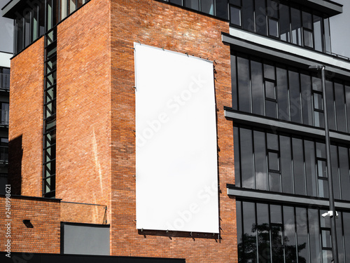 University, company office building facade, Blank white paper board at grunge brick red wall texture background, Mock up ads template, Business presentation content concept. 