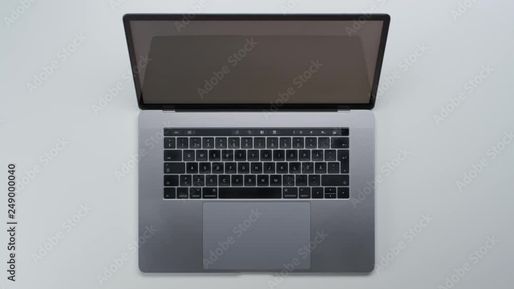 Male hands typing laptop on white clean minimalistic table with top view, gestures and finger movements Male hands typing laptop on white clean minimalistic table with top view, gestures and finger movements