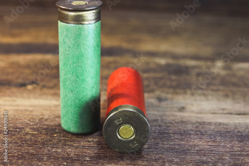 old hunting cartridges on a wooden background.