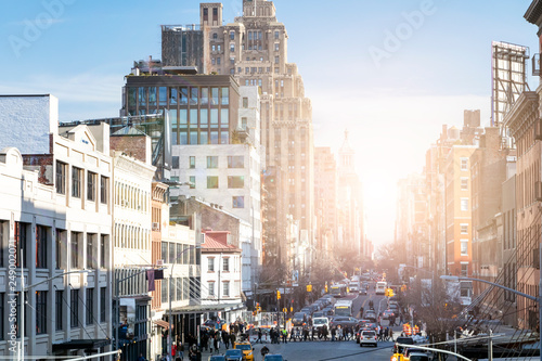 Busy view of 14th Street with crowds of people and sunlight background scene from the Highline Park in Chelsea New York City