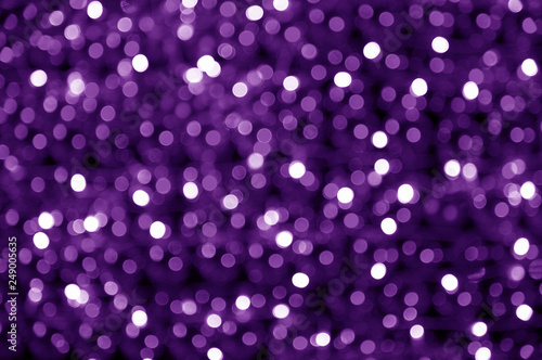 abstract blurred glowing light particles of shades of purple and white