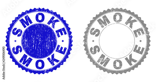Grunge SMOKE stamp seals isolated on a white background. Rosette seals with grunge texture in blue and grey colors. Vector rubber stamp imprint of SMOKE label inside round rosette.