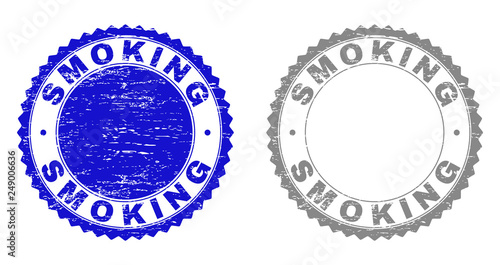 Grunge SMOKING stamp seals isolated on a white background. Rosette seals with grunge texture in blue and gray colors. Vector rubber stamp imprint of SMOKING title inside round rosette.