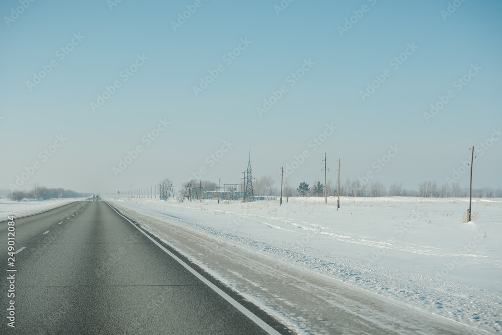 The road in winter. Asphalt road in winter. Road under the snow. The road in winter. Asphalt road in winter. Road under the snow.