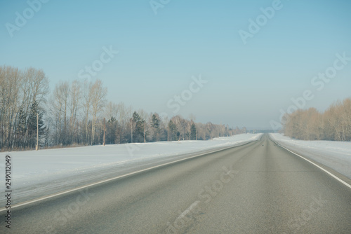 The road in winter. Asphalt road in winter. Road under the snow.