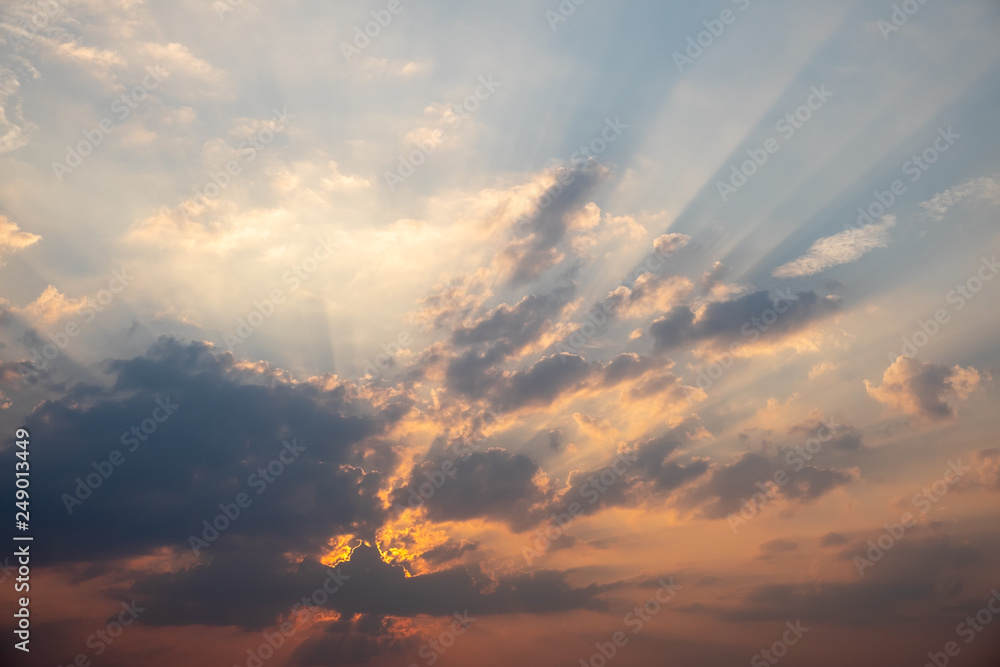 Blue and orange sunset sky with rays of sun. Natural landscape for background Blue and orange sunset sky with rays of sun. Natural landscape for background