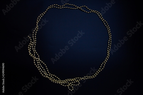 Circle golden beads, empty frame, black background