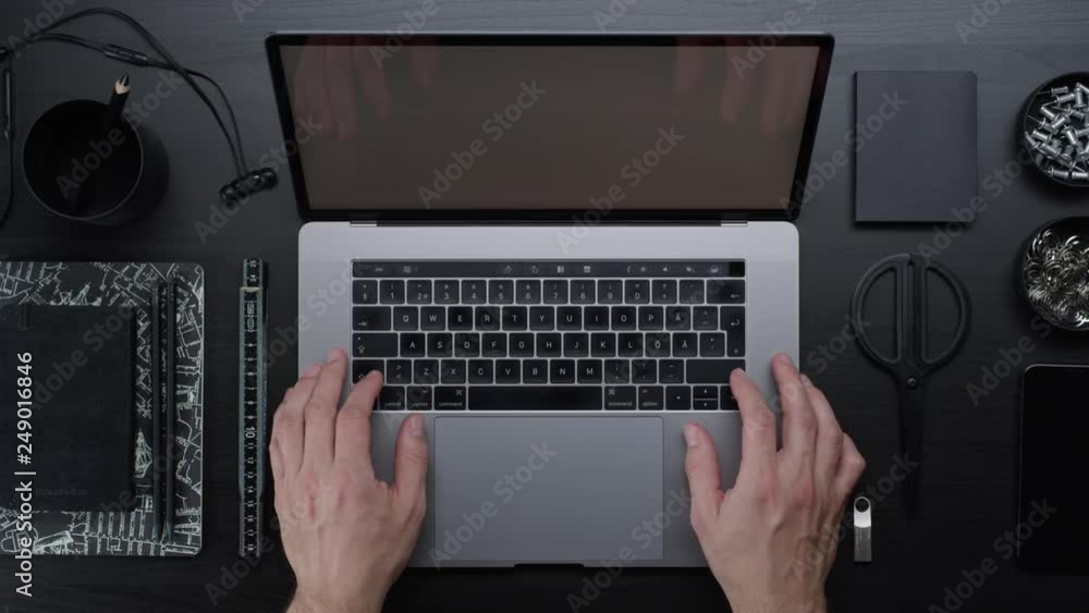 Male hands typing laptop on black clean minimalistic table with top view, gestures and finger movements Male hands typing laptop on black clean minimalistic table with top view, gestures and finger movements