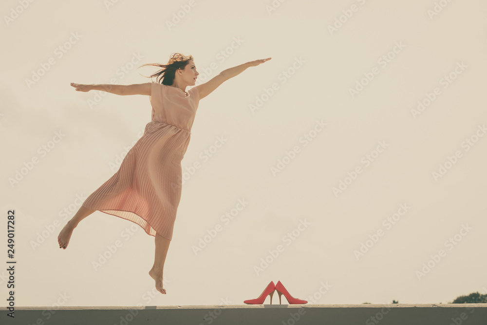 Woman dancing wearing long light pink dress