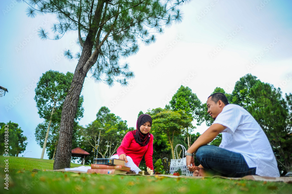 A young couple spend their time together at park to enjoy the day A young couple spend their time together at park to enjoy the day