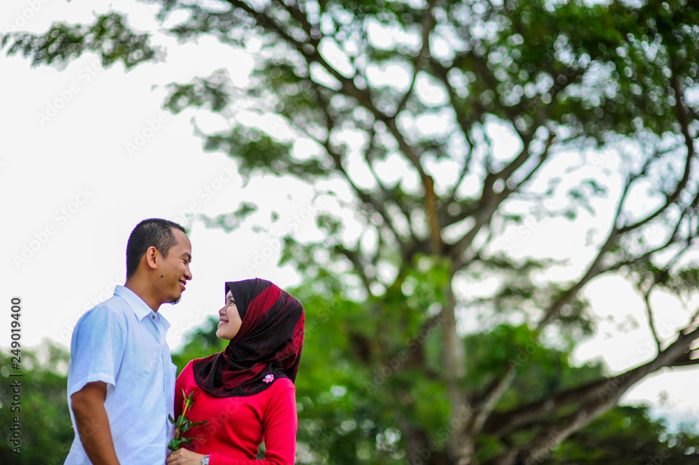 Young couple in love at the park enjoy the together. A happiness couple together. Young couple in love at the park enjoy the together. A happiness couple together.