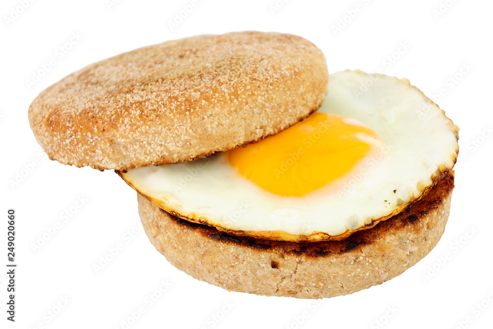 Fried egg on a soft toasted wholemeal English muffin isolated on a white background