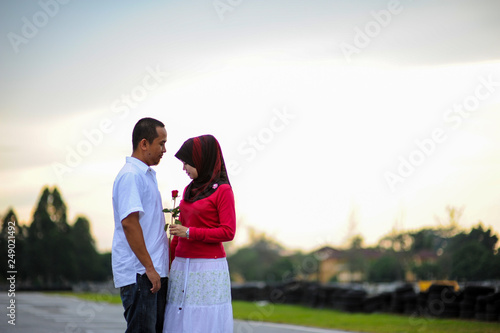 Couple outdoors enjoying a evening day looking happy together. Malay couple in Malaysia © Mhilmi Osman