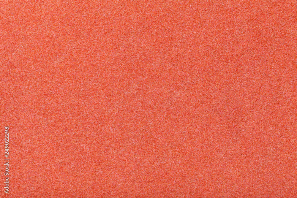 Fototapeta premium Dark orange matt suede fabric closeup. Velvet texture of felt.